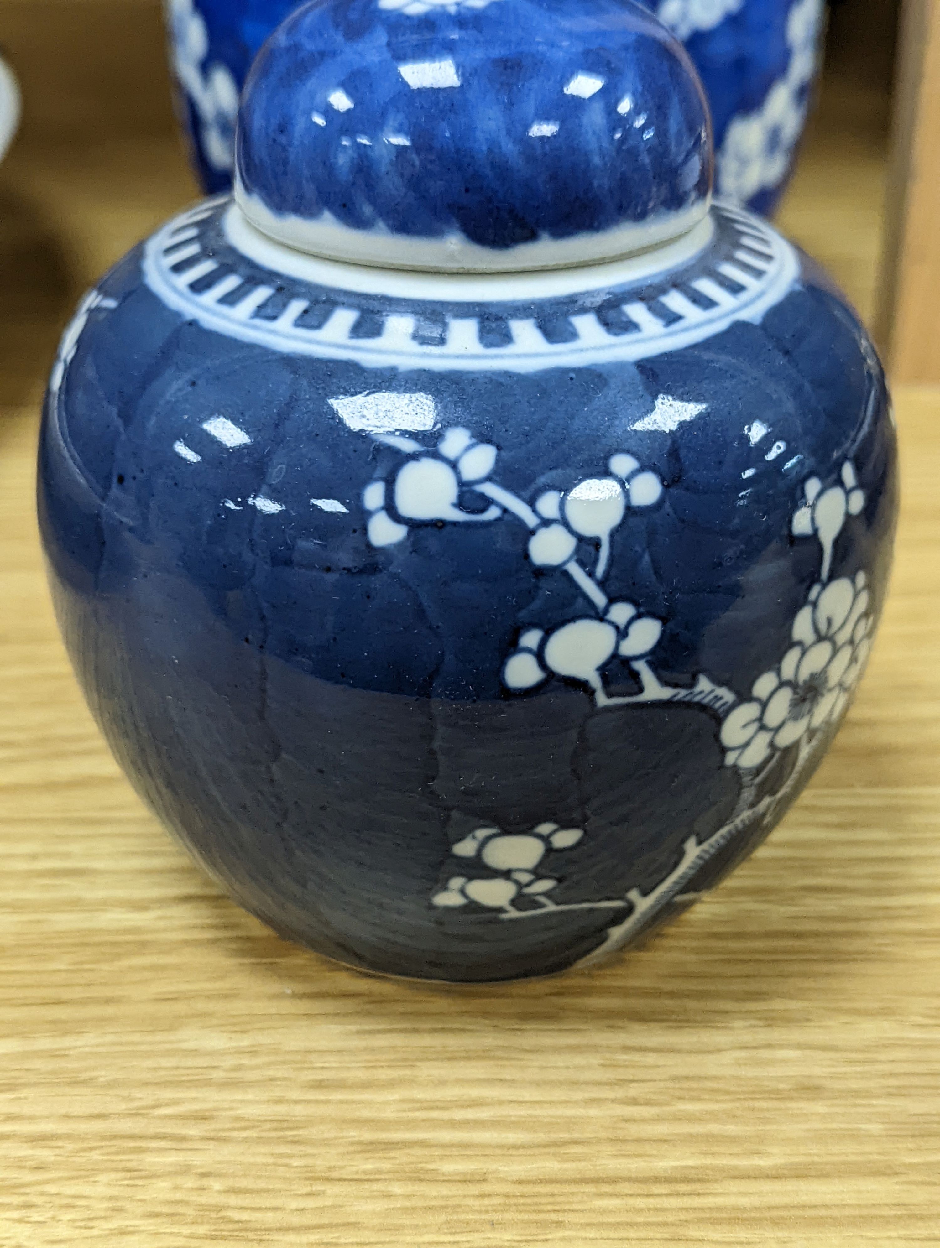 Three Chinese blue and white prunus decorated jars and covers, 19th/20th century, with four character marks 18cm